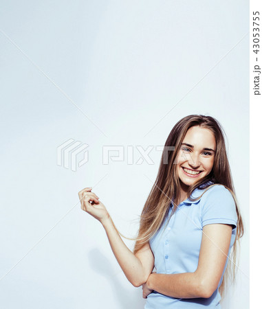 young pretty teenage hipster girl posing emotional happy smiling on white background, lifestyle 43053755