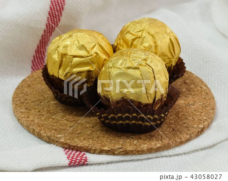 Brown Round Chocolate Candies in Gold Package 43058027