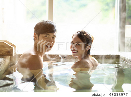 Young couple relaxing in hot springs Young couple relaxing in hot springs 43058977