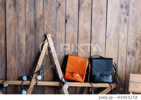 two leather bags on a wooden background 43063258