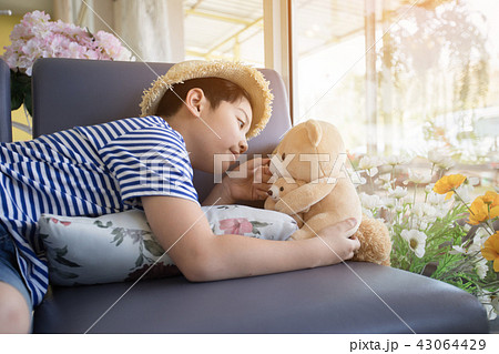 Lovely moment of asian cute boy playing with doll. Lovely moment of asian cute boy playing with doll. 43064429