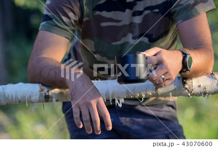 Man drinking coffee on fenced ranch Man drinking coffee on fenced ranch 43070600