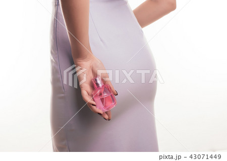 Beautiful young woman with bottle of perfume  43071449