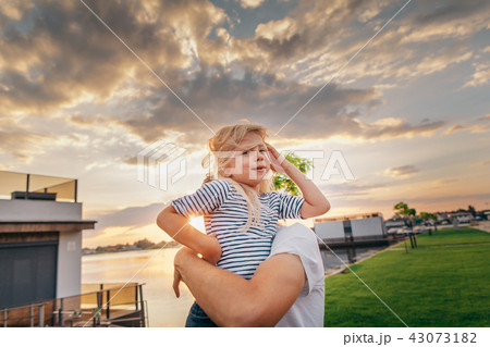 Positive girl having fun with parent outside 43073182