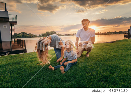 Happy parents spending time with kid outside 43073189