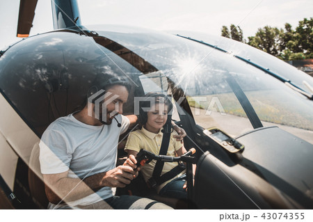 Positive father and glad child controlling helicopter 43074355