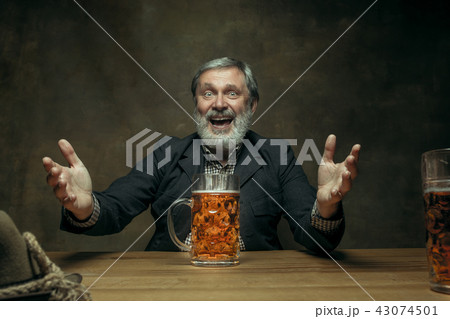 Smiling bearded male drinking beer in pub 43074501