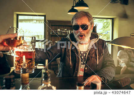 The senior bearded male drinking beer in pub 43074647