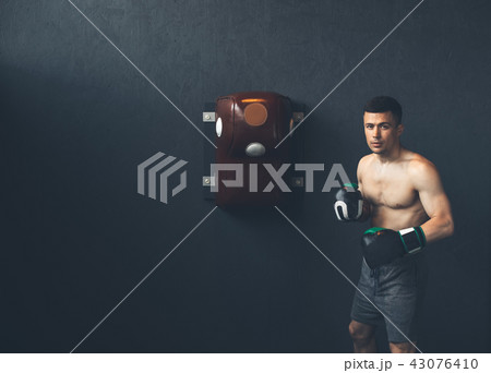 Topless fighter is training in sport center 43076410