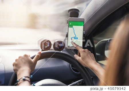 woman using gps navigation map on smartphone woman using gps navigation map on smartphone 43079342