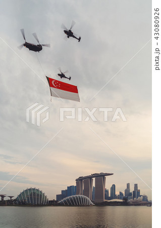 Helicopters carrying Singapore flag over downtown Singapore city Helicopters carrying Singapore flag over downtown Singapore city 43080926