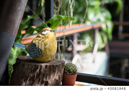 Yellow bird statue on wooden table Yellow bird statue on wooden table 43081948