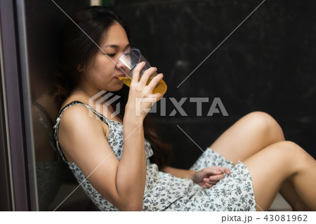 Depressed Asian woman drink beer 43081962