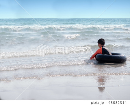 little Asian boy play waves on the beach little Asian boy play waves on the beach 43082314
