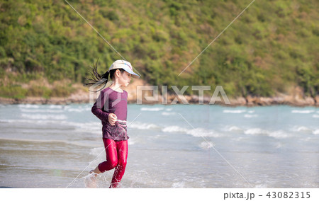 little Asian girl run play waves on the beach little Asian girl run play waves on the beach 43082315