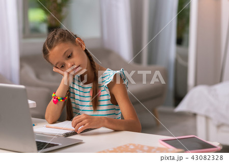 Sad unhappy girl looking at the copybook 43082328