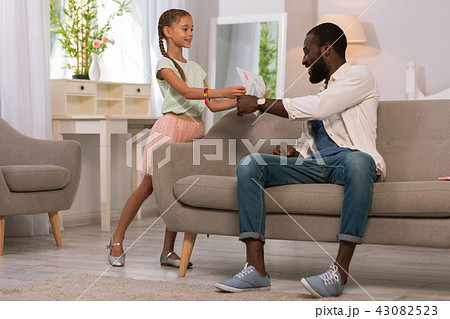 Joyful happy girl showing her father a drawing 43082523