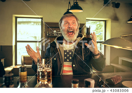 The senior bearded male drinking beer in pub 43083006