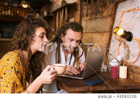 Woman drinking tea and watching her man working Woman drinking tea and watching her man working 43083230