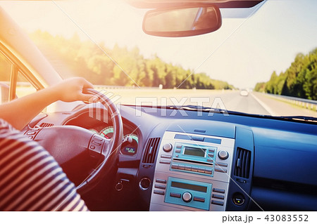 driver driving a car on asphalt road in summer 43083552
