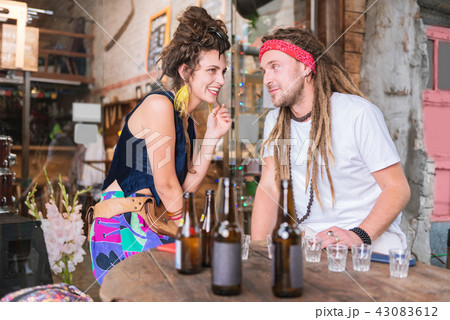 Dark-haired hippie woman wearing bright yellow earrings Dark-haired hippie woman wearing bright yellow earrings 43083612