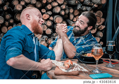 Two beaming mature men having fun while drinking beer Two beaming mature men having fun while drinking beer 43083616