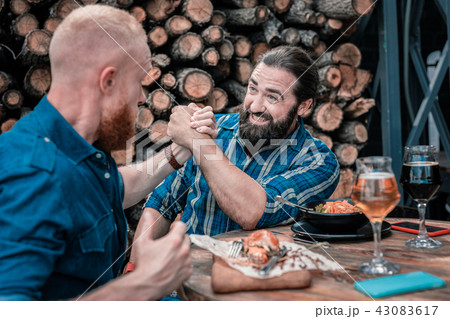 Dark-haired bearded man shaking hand of his friend 43083617