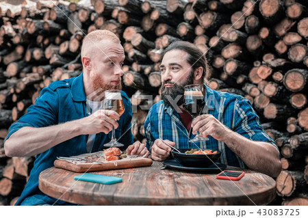 Two bearded mature men enjoying taste of delicious craft beer 43083725