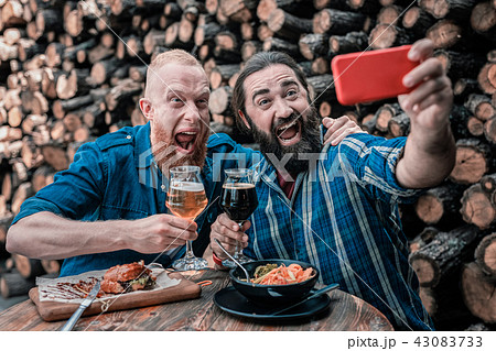 Two mature businessmen making photo together sitting in pub 43083733