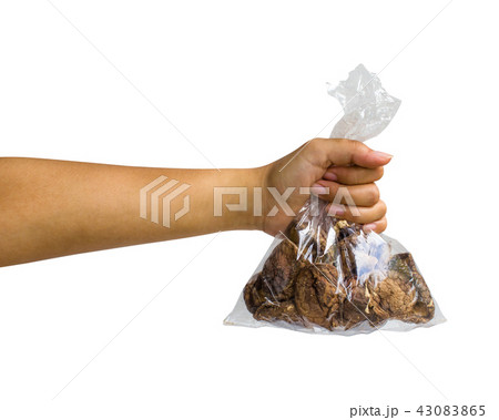 Hand holding dried shiitake mushroom isolated. 43083865