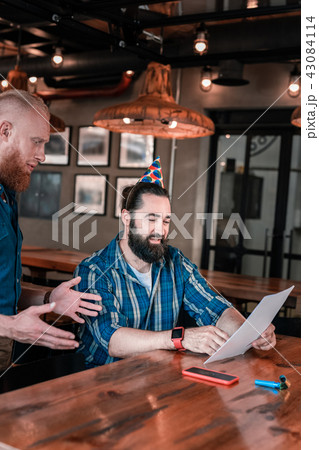 Bearded birthday man choosing some drinks for his guests Bearded birthday man choosing some drinks for his guests 43084114