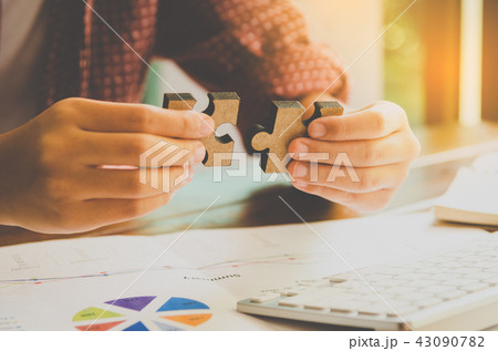 Business people are taking puzzles to connect. 43090782