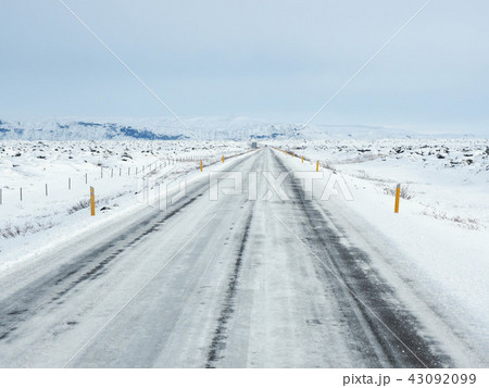 Winter road with mountain on the side of the road Winter road with mountain on the side of the road 43092099