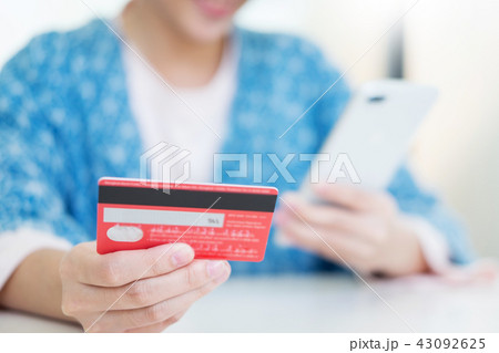 Online shopping concept. hand of happy young holding smartphone Online shopping concept. hand of happy young holding smartphone 43092625