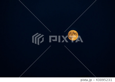 Big moon in its full phase with detailed craters visible on its edges, all in a black background Big moon in its full phase with detailed craters visible on its edges, all in a black background 43095231