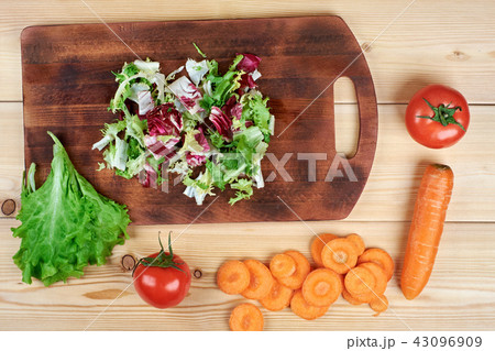 Cooking, Vegetarian Concept. Ready to make salad.A cutting board, a knife, vegetables and spices on Cooking, Vegetarian Concept. Ready to make salad.A cutting board, a knife, vegetables and spices on 43096909