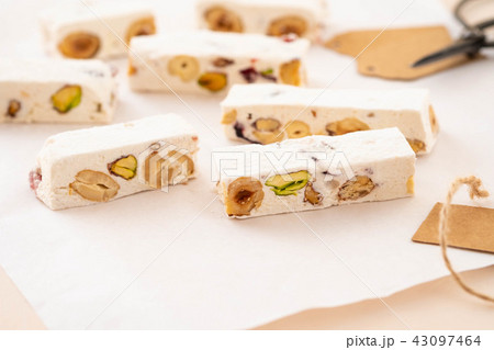 Piece of traditional nougat, on white background. Christmas concept. Copy space. 43097464