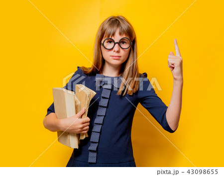 Portrait of a nerd girl in glasses with books Portrait of a nerd girl in glasses with books 43098655