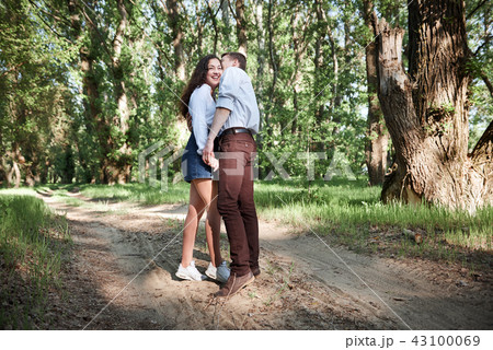 young couple walking in the forest, summer nature 43100069