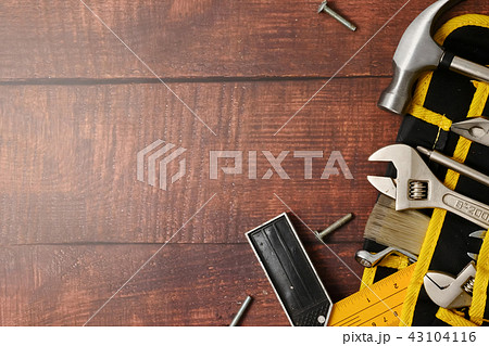 Construction worker belt with tools on wooden table background. Construction worker belt with tools on wooden table background. 43104116