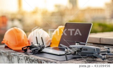 Drone, remote control, laptop and helmet at site Drone, remote control, laptop and helmet at site 43109456