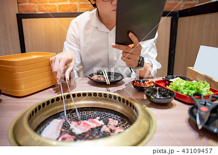 Asian man eating Korean Barbecue buffet Asian man eating Korean Barbecue buffet 43109457