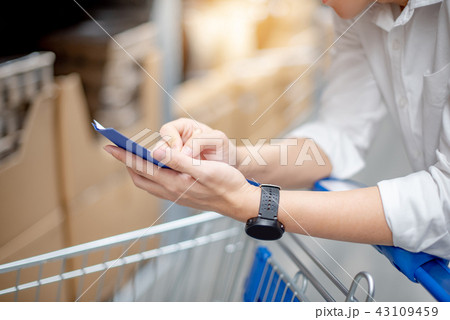 Asian man checking the shopping list in warehouse Asian man checking the shopping list in warehouse 43109459
