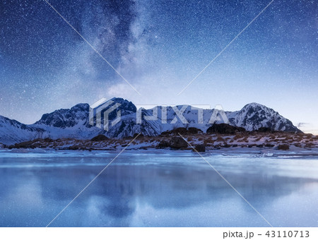 Night sky and reflection on the frozen lake. 43110713