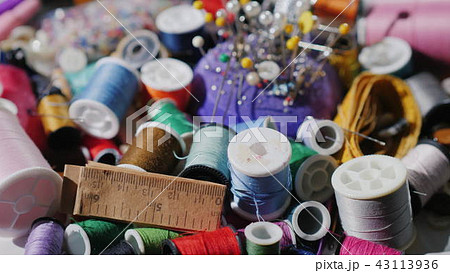 A set for sewing and needlework. Threads, needles and pins slowly rotate A set for sewing and needlework. Threads, needles and pins slowly rotate 43113936