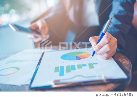 woman hand writing on charts and graphs. 43126485