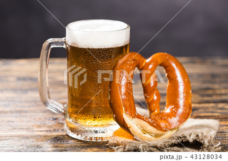 Alcohol, liquid, food concept - a huge cup of beer on a table with a bagel 43128034