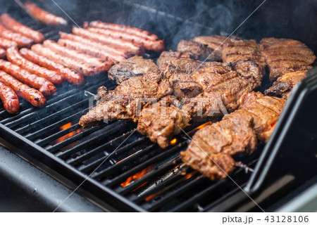 Barbecue grill bbq on propane gas grill steaks bratwurst sausages meat meal 43128106