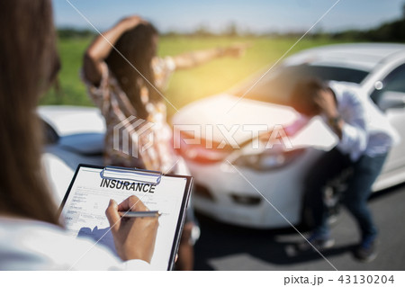 Insurance agent writing on clipboard. Insurance agent writing on clipboard. 43130204