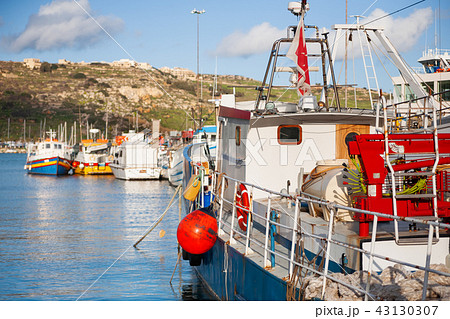 Colorful fisher boats at pier. Mgarr, Gozo, Malta. Colorful fisher boats at pier. Mgarr, Gozo, Malta. 43130307